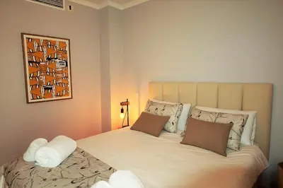 a bedroom with a large bed with two pillows at House J São Rafael - By Bedzy in Albufeira