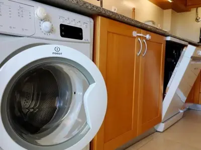 a white washing machine sitting in a kitchen at Happiness Apartment by Stay ici Algarve Holiday Rental in Albufeira