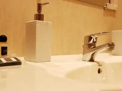 a bathroom sink with a roll of toilet paper on it at Happiness Apartment by Stay ici Algarve Holiday Rental in Albufeira