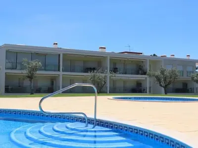 a swimming pool in front of a building at Happiness Apartment by Stay ici Algarve Holiday Rental in Albufeira