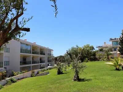 an image of a building with a green yard at Happiness Apartment by Stay ici Algarve Holiday Rental in Albufeira