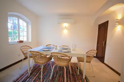 a dining room with a white table and chairs at Qta do Eucalipto Villa in Faro