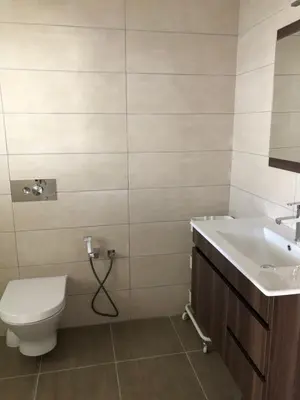 a bathroom with a toilet and a sink at Debimar Apartamentos in Albufeira
