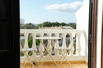 a balcony with a table and two chairs at Villa a Sul in Albufeira