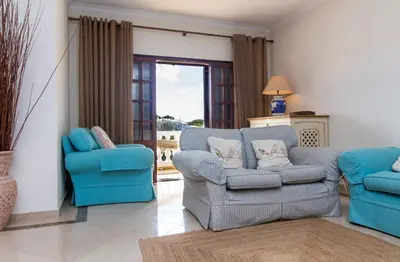 a living room with two chairs and a couch at Villa a Sul in Albufeira