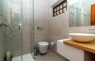 a bathroom with a sink and a glass shower at Villa a Sul in Albufeira