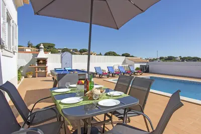 a living room with two couches and a table at Villa Goia by Villa Plus in Olhos de Água