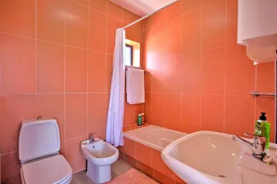 a bathroom with a sink and a toilet and a tub at Villa Jorge by Villa Plus in Albufeira