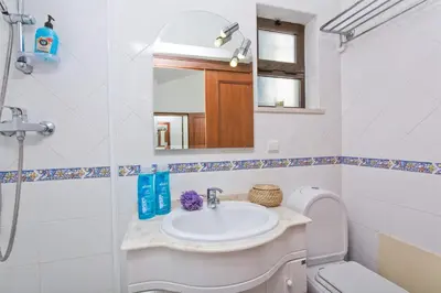 a bathroom with a sink and a toilet and a mirror at Villa Neptuno Sol by Villa Plus in Albufeira