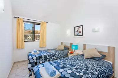 a bedroom with two beds and a window at Villa Neptuno Sol by Villa Plus in Albufeira