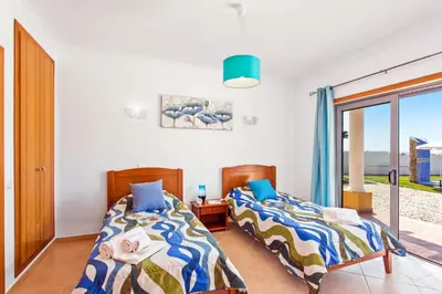 two beds in a room with a window at Villa Ribeiro Tomas by Villa Plus in Loulé