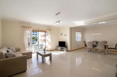 a living room with a couch and a table at Apartamento Água Brisa in Albufeira