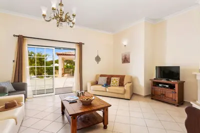 a living room with a couch and a tv at Villa Arvela by Villa Plus in Galé