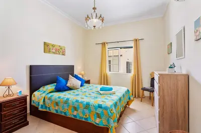 a bedroom with a bed and a dresser and a window at Villa Arvela by Villa Plus in Galé