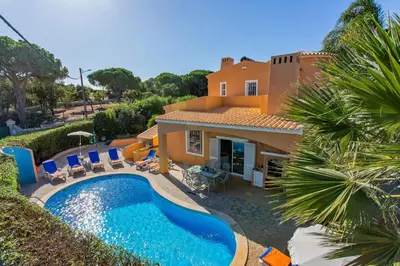 a villa with a swimming pool in front of a house at Villa Casa do Mel by Villa Plus in Loulé