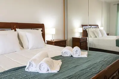 a hotel room with two beds with towels on them at Miral 2 - Beach front apartment with pool in Quarteira