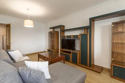 a living room with a couch and a tv at Miral 2 - Beach front apartment with pool in Quarteira