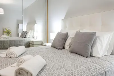 a bedroom with a large bed with towels on it at Miral 2 - Beach front apartment with pool in Quarteira