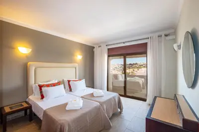 a room with a bed and a balcony with a view at #018 T2 Elisabete by Home Holidays in Albufeira