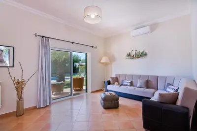 a living room with a couch and a table at Villa Celia by Villa Plus in Olhos de Água