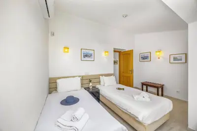 two beds in a room with white walls at Villa Eliza by Villa Plus in Albufeira