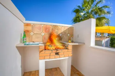 a fireplace in a backyard with a fire pit at Villa Flor by Villa Plus in Guia