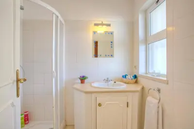 a white bathroom with a sink and a shower at Villa Flor by Villa Plus in Guia