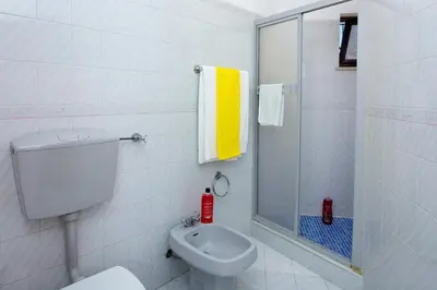 a white bathroom with a toilet and a shower at Villa Gregorio by Villa Plus in Galé