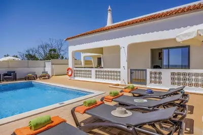 a villa with a swimming pool and a house at Villa Marrachinho by Villa Plus in Albufeira