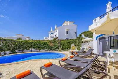 a group of lounge chairs and a swimming pool at Villa Casa Michelle by Villa Plus in Almancil
