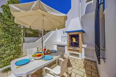a patio with chairs and a swimming pool at Villa Casa Michelle by Villa Plus in Almancil