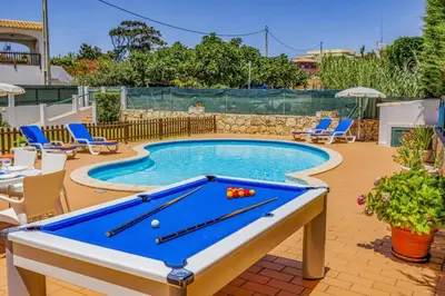 a pool table in the middle of a yard at Villa Praia by Villa Plus in Galé