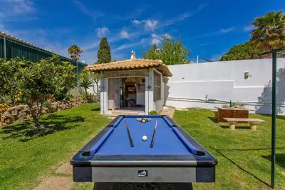 a pool table in the backyard of a house at Villa Rocchi by Villa Plus in Albufeira