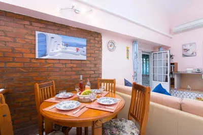 a dining room with a table and a couch at Villa Rocchi by Villa Plus in Albufeira