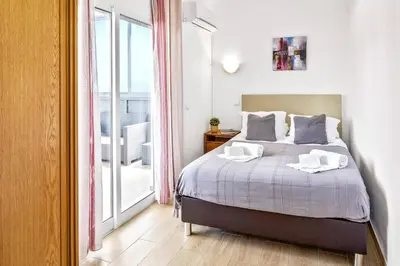 a bedroom with a large bed and a window at Villa Sea Star by Villa Plus in Albufeira