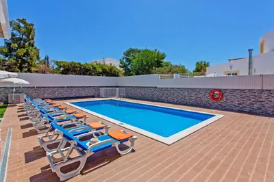 a swimming pool with chaise lounge chairs and a swimming pool at Villa Sea Star by Villa Plus in Albufeira