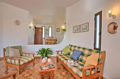 a living room with two couches and a table at Villa Vitor by Villa Plus in Albufeira