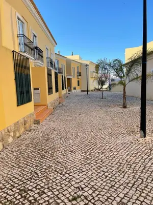 a cobblestone street in front of some buildings at Moradia da Encosta- Vilamoura in Vilamoura
