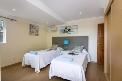 a swimming pool with lounge chairs and a house at Villa Amora by Villa Plus in Vale do Lobo