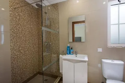 a bathroom with a toilet and a sink and a shower at Villa Amora by Villa Plus in Vale do Lobo