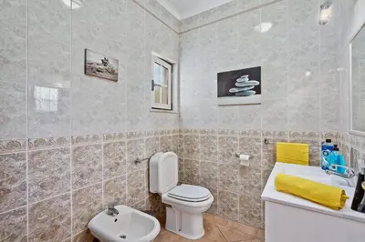 a bathroom with a toilet and a sink at Villa Bali by Villa Plus in Albufeira