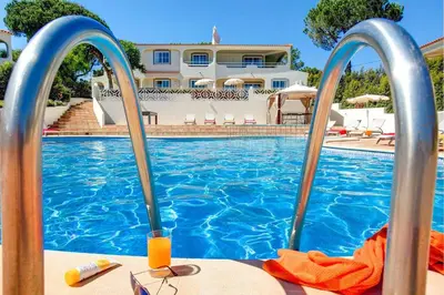 a swimming pool in front of a villa at Villa Beirais by Villa Plus in Vale do Lobo