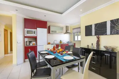 a kitchen and dining room with a table and chairs at Villa Bolina by Villa Plus in Albufeira