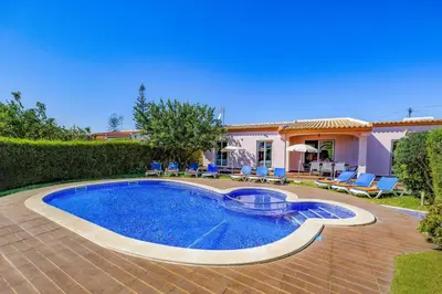 a villa with a swimming pool and a house at Villa Bolina by Villa Plus in Albufeira