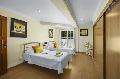 a hotel room with two beds and a sink at Villa Canas by Villa Plus in Vale do Lobo