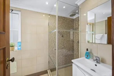 a bathroom with a shower and a sink at Villa Canas by Villa Plus in Vale do Lobo