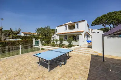 a ping pong table in front of a house at Villa Canas by Villa Plus in Vale do Lobo