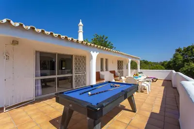 a pool table on the patio of a house at Villa Citrinos by Villa Plus in Almancil