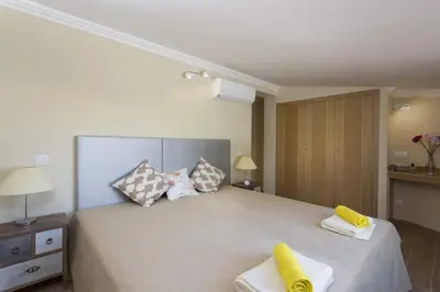 a bedroom with a large bed with two towels on it at Villa Siroco by Villa Plus in Albufeira