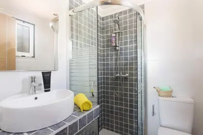 a bathroom with a sink and a glass shower at Villa Siroco by Villa Plus in Albufeira